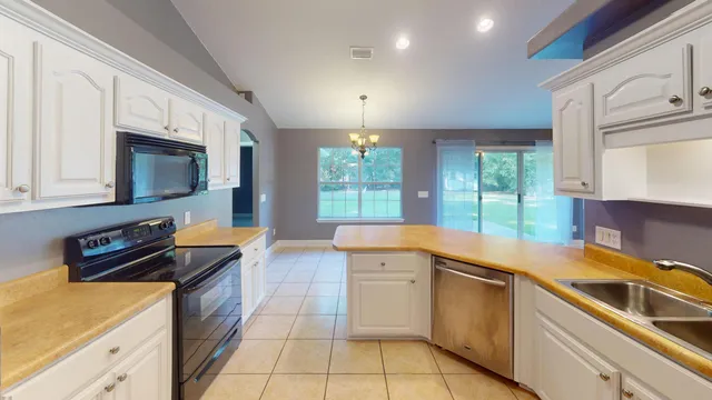 a kitchen that has a sink and a stove