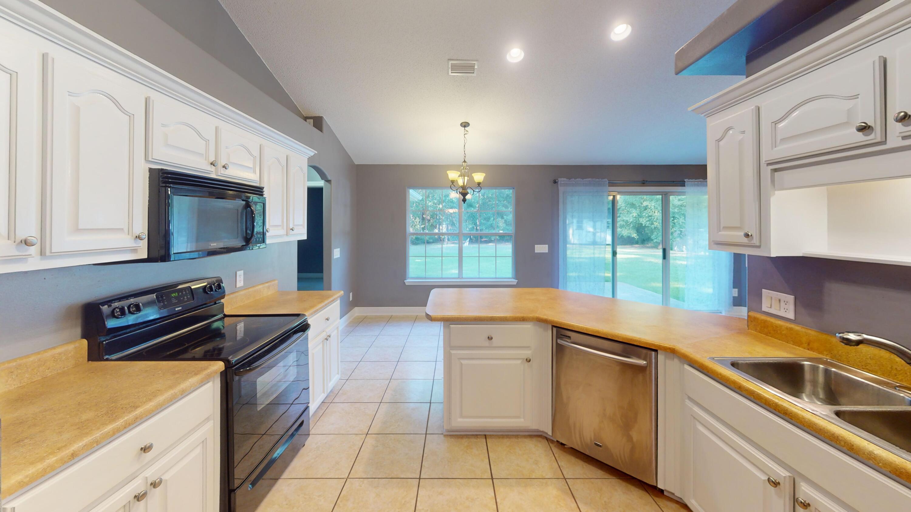 8118 Menorca Street Navarre, FL 32566 - Photo 2 of 14 a kitchen that has a sink and a stove