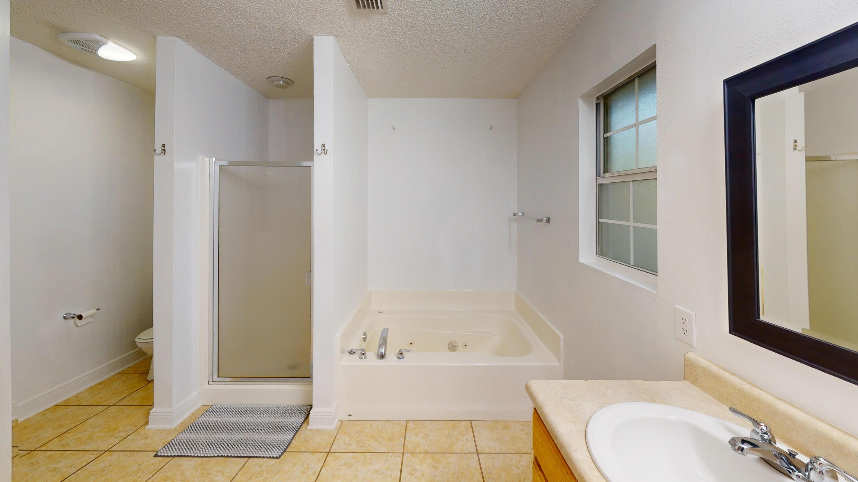 8118 Menorca Street Navarre, FL 32566 - Photo 6 of 14 a bathroom with a sink toilet and shower