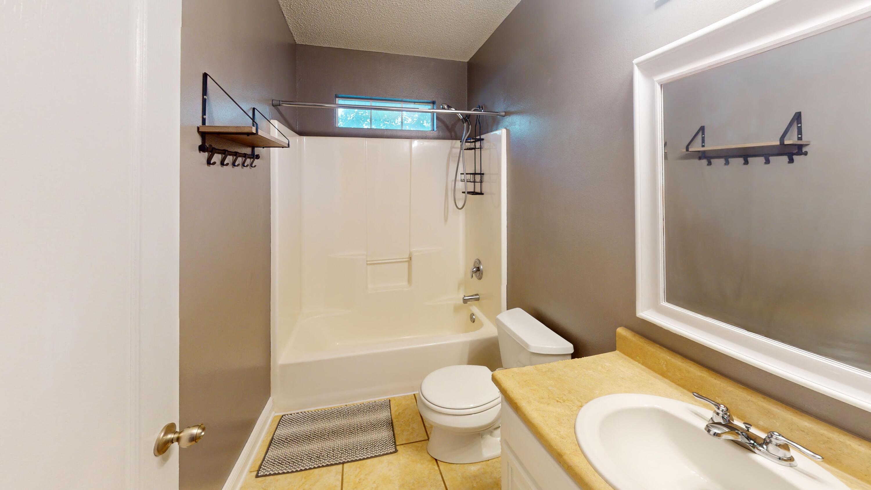 8118 Menorca Street Navarre, FL 32566 - Photo 9 of 14 a bathroom with a sink toilet and shower