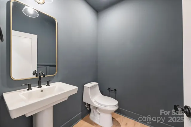a bathroom with a toilet sink and mirror
