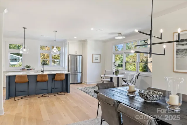 a room with stainless steel appliances kitchen island granite countertop furniture and a window