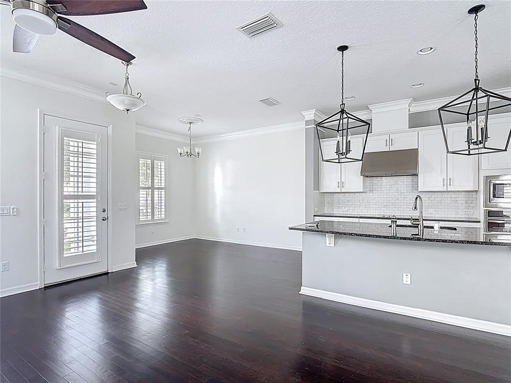 1513 Resolute Street Celebration, FL 34747 - Photo 11 of 43 a view of a room with stainless steel appliances wooden floor and windows