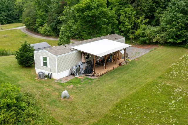 an aerial view of a house with swimming pool and big yard