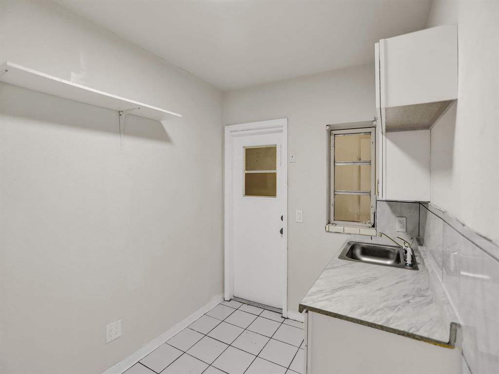 535 Northwest 91st Street, Unit 2 Miami, FL 33150 - Photo 12 of 20 a bathroom with a granite countertop sink and a mirror