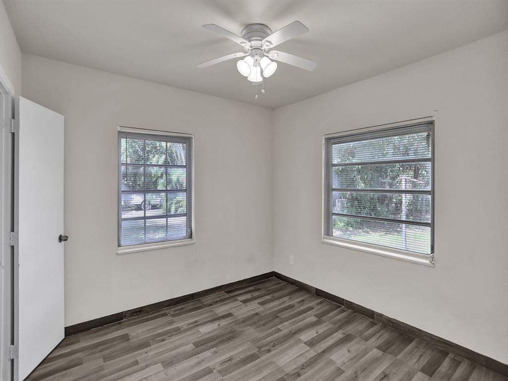 535 Northwest 91st Street, Unit 2 Miami, FL 33150 - Photo 14 of 20 a view of an empty room with a window and wooden floor