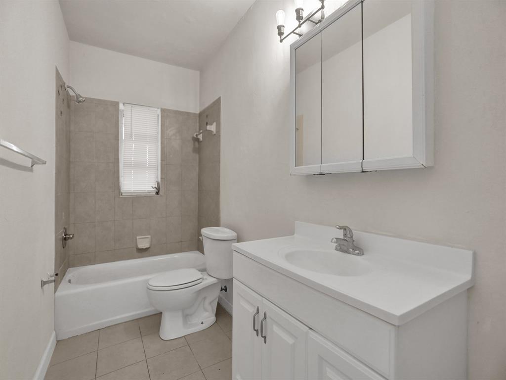 535 Northwest 91st Street, Unit 2 Miami, FL 33150 - Photo 4 of 20 a bathroom with a sink a toilet and shower