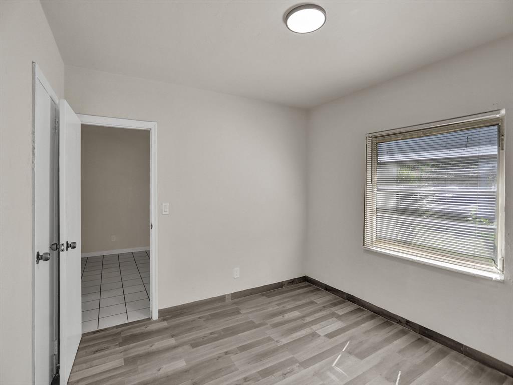 535 Northwest 91st Street, Unit 2 Miami, FL 33150 - Photo 9 of 20 a view of an empty room with wooden floor and a window