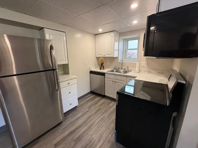 a kitchen with a sink stainless steel appliances and cabinets