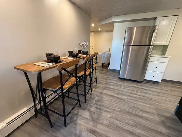 a view of a room with furniture and wooden floor