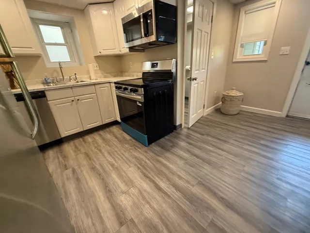 a kitchen with stainless steel appliances granite countertop a stove and a sink