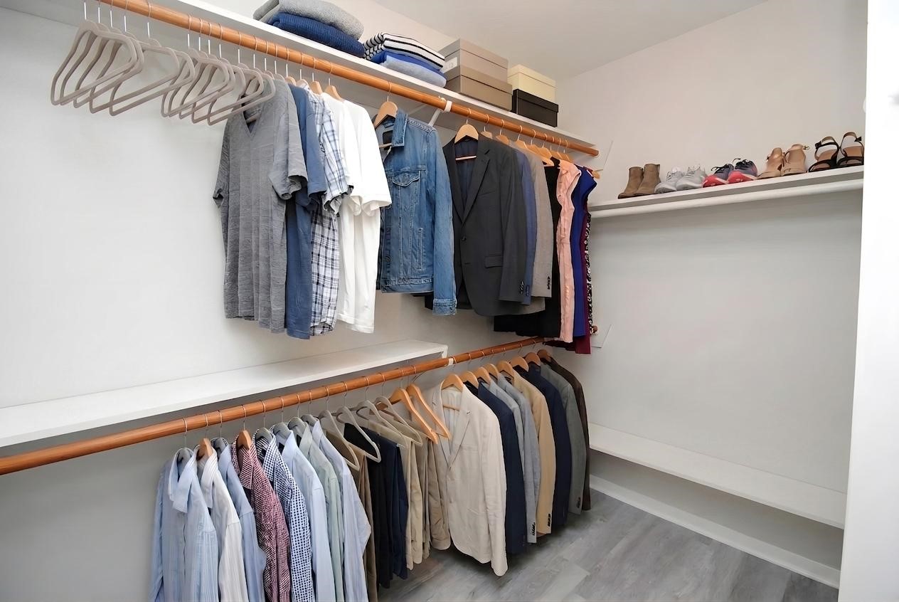 22831 John Rolfe Lane Katy, TX 77449 - Photo 25 of 34 a view of walk in closet with clothes and shoes