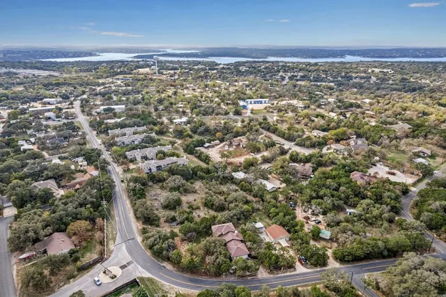 an aerial view of a houses with a yard