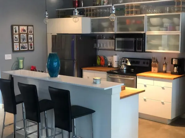 a kitchen with a table chairs stove and cabinets