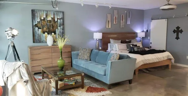 a living room with furniture and a chandelier
