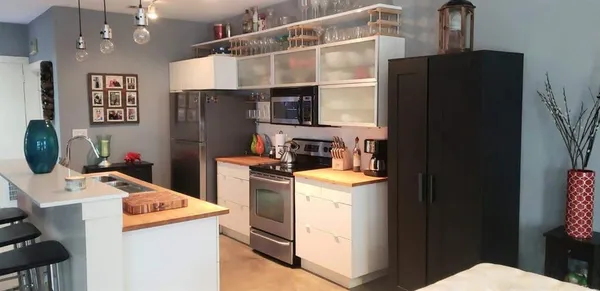 a kitchen with a refrigerator and cabinets