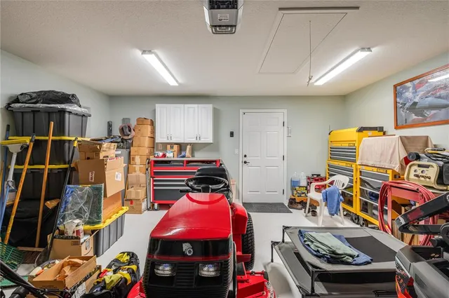 a view of an empty room with floor to ceiling windows with yard