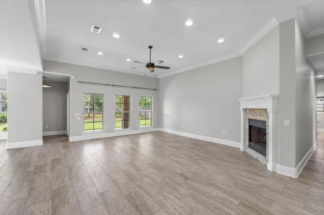 a kitchen with a stove a sink a center island and a wooden floor