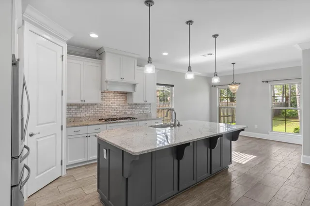 a kitchen with stainless steel appliances granite countertop a stove microwave and refrigerator