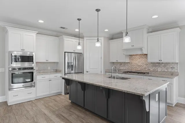 a view of empty room with wooden floor and windows