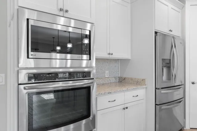 a view of room with cabinets and wooden floor
