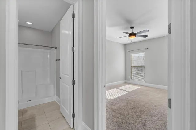 a bathroom with a tub sink shower and mirror