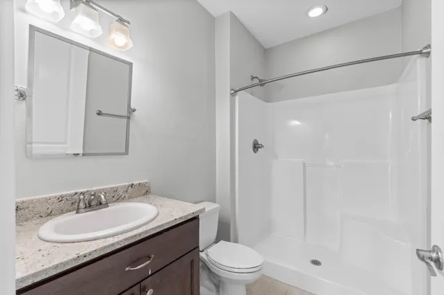 a bathroom with a granite countertop sink mirror and double