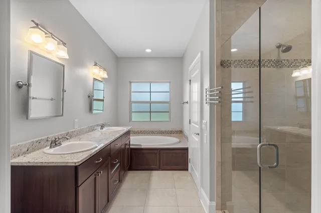 a bathroom with a granite countertop sink toilet and mirror