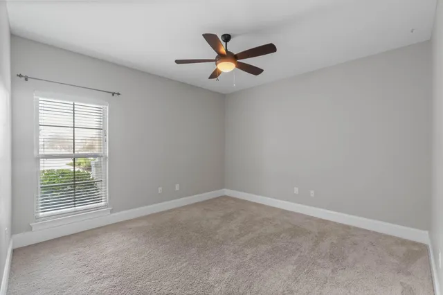 a view of a fountain in a yard with palm trees