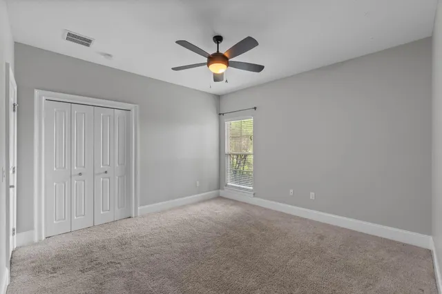 a front view of a house with yard and green space