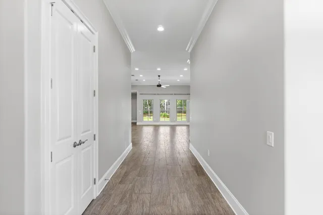an empty room with wooden floor and a fireplace