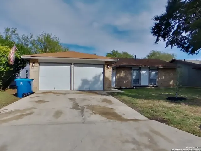 a front view of a house with a garden and plants