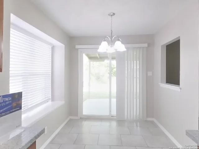 a view of a room with windows and chandelier