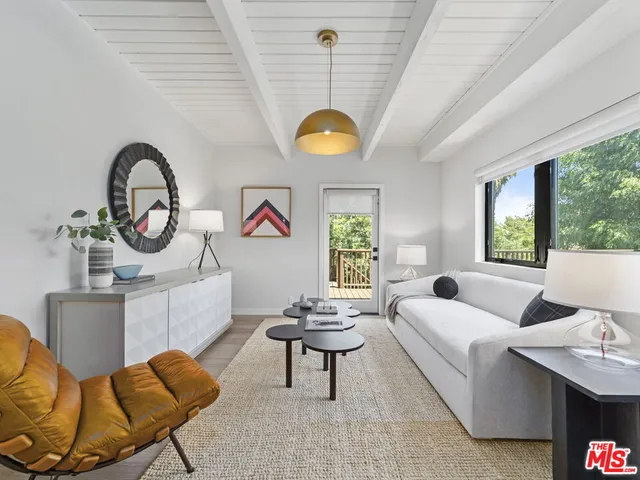 a living room with furniture a window and a chandelier