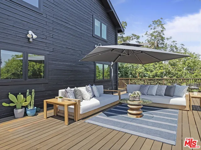 a view of a patio with couches and potted plants