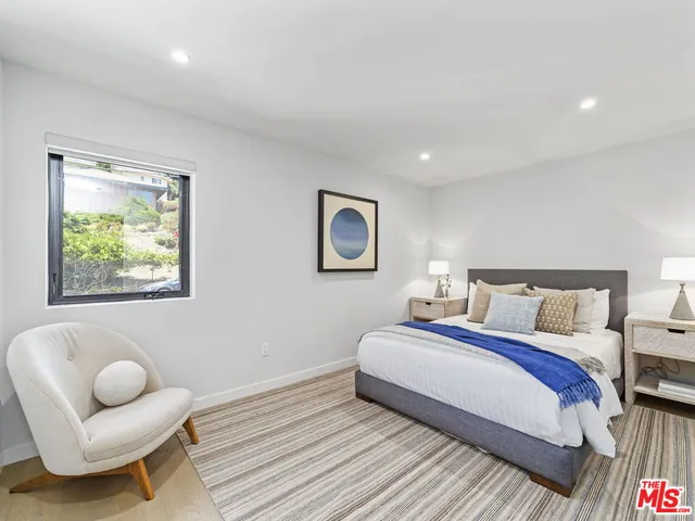 a spacious bedroom with a bed and a couch