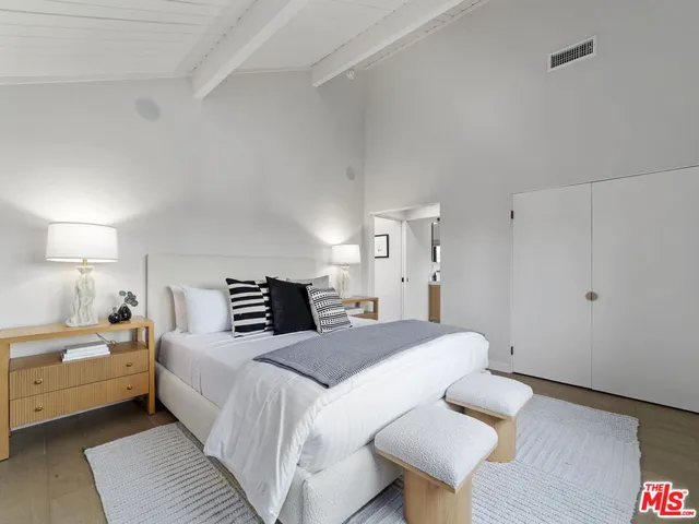 a bedroom with a bed and a couch