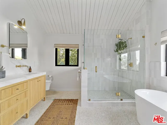 a bathroom with a bathtub a sink and a shower