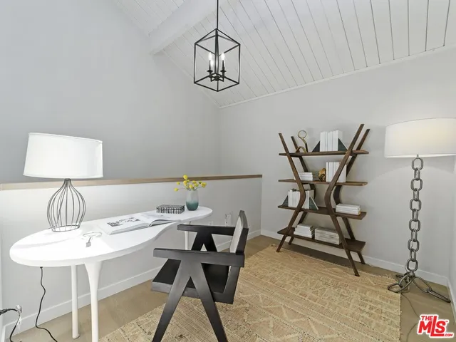 a view of a dining room with furniture and a chandelier