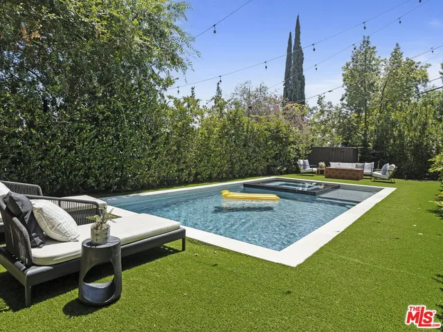 a view of a backyard with plants and lake view