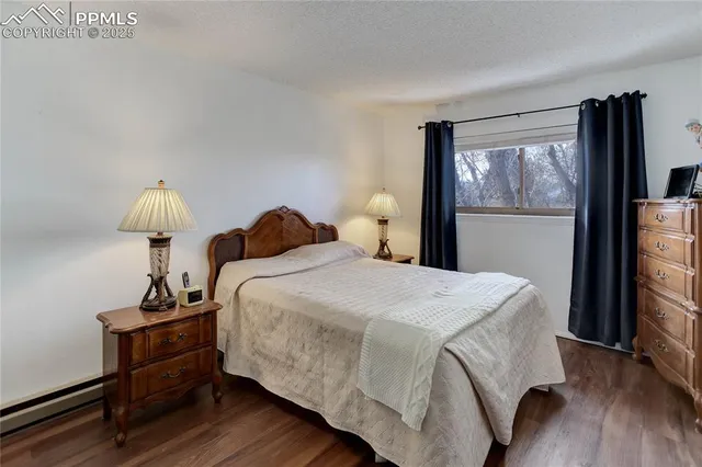 a bedroom with a bed and a flat tv screen on the dresser