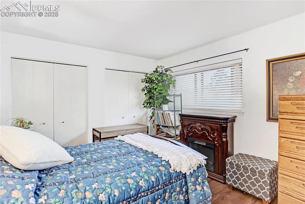 5102 Rainbow Harbour Circle Colorado Springs, CO 80917 - Photo 16 of 25 a bedroom with a bed and a fireplace