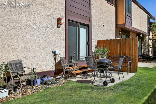 a view of a patio with table and chairs and potted plants