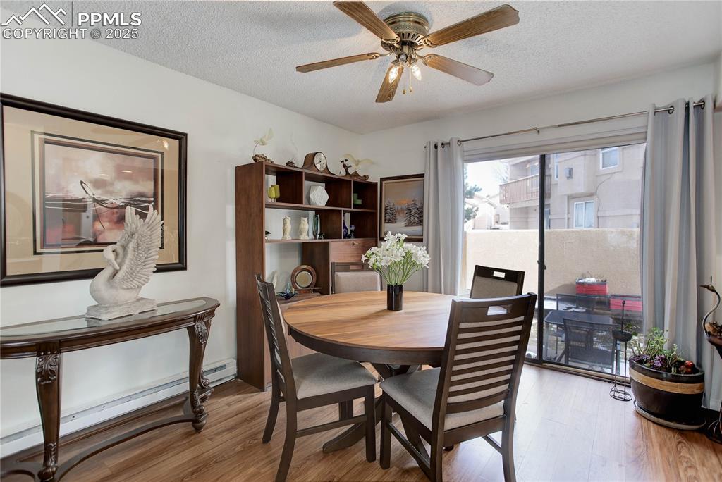 5102 Rainbow Harbour Circle Colorado Springs, CO 80917 - Photo 7 of 25 a view of a dining room with furniture window and wooden floor
