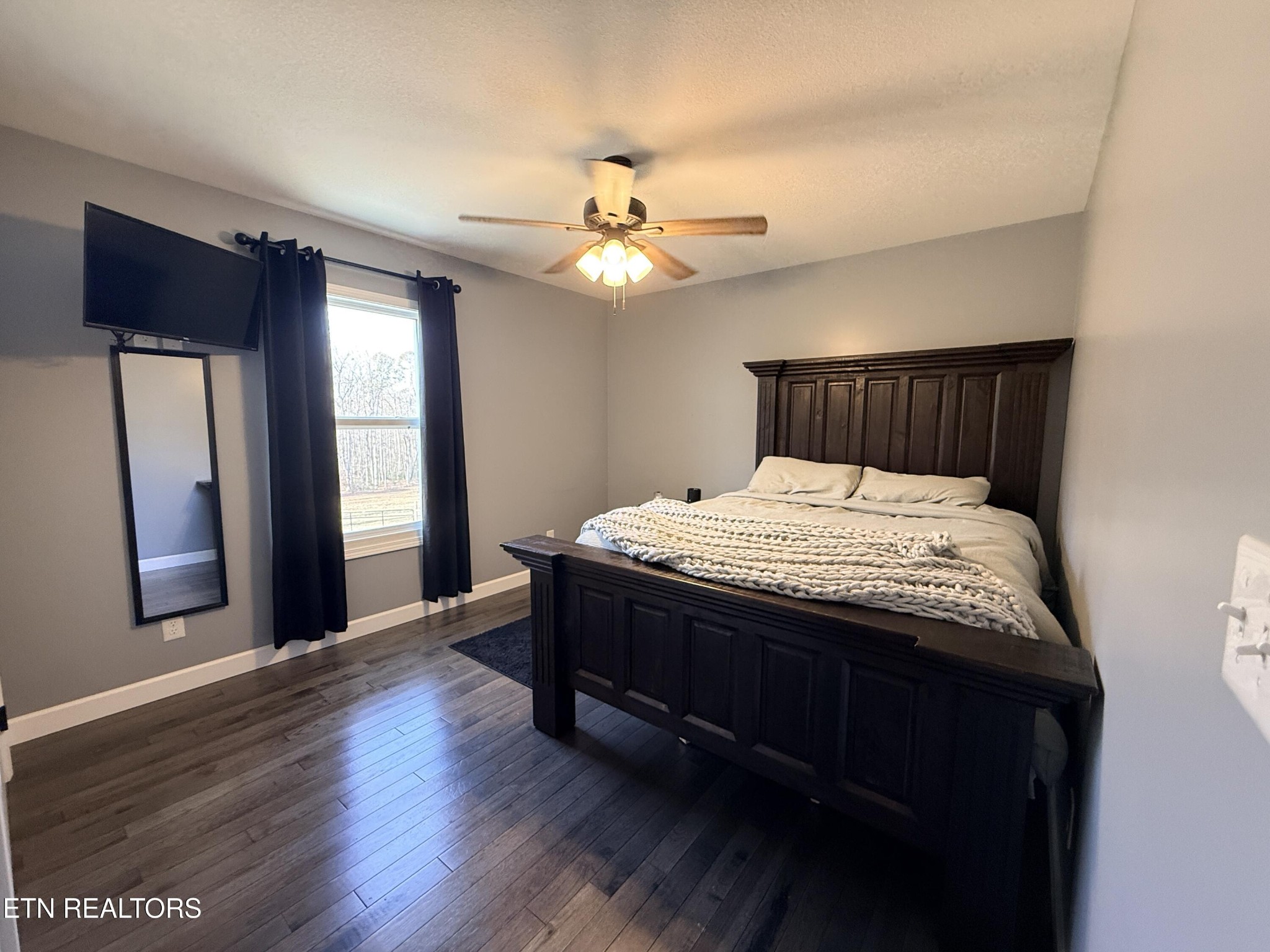 1926 Old Grimsley Road Grimsley, TN 38565 - Photo 24 of 41 a bed sitting in a bedroom next to a window and a chandelier