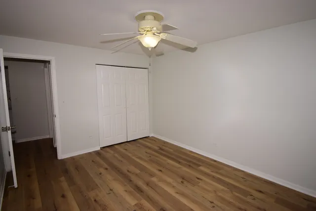 a view of a room with wooden floor