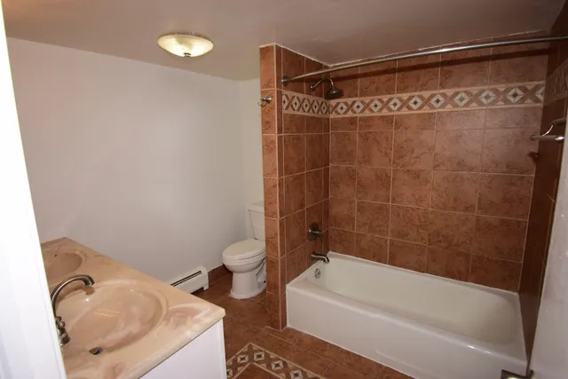 a bathroom with a toilet and a bathtub