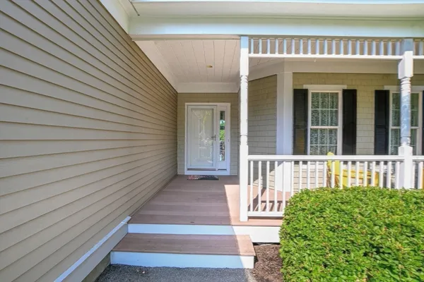 a living room with furniture fireplace and a large window