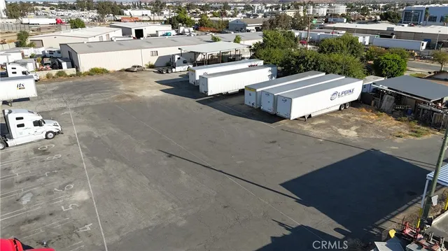 a view of a patio with table and chairs potted plants with wooden floor and fence