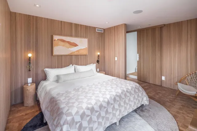 a bedroom with a bed and a painting